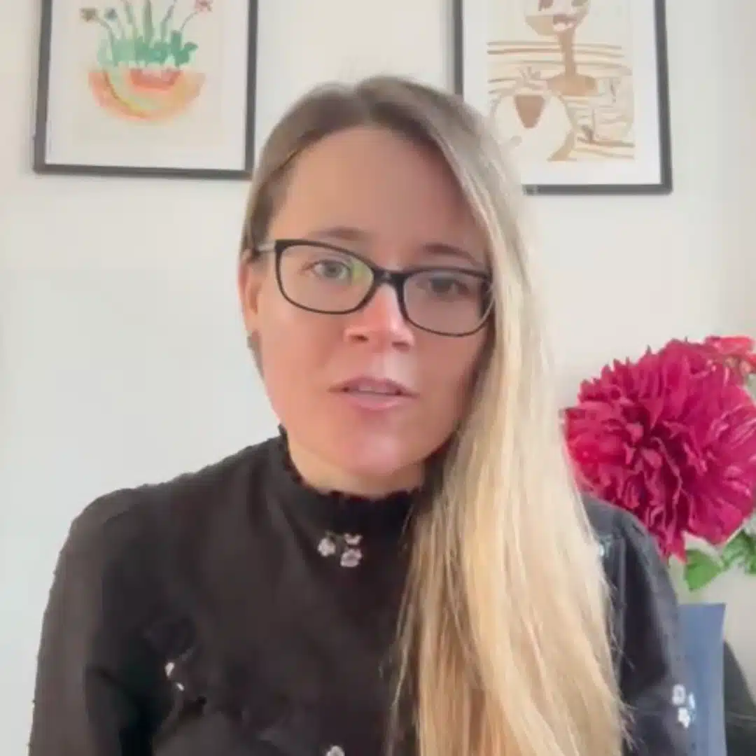 a woman with long hair wearing glasses