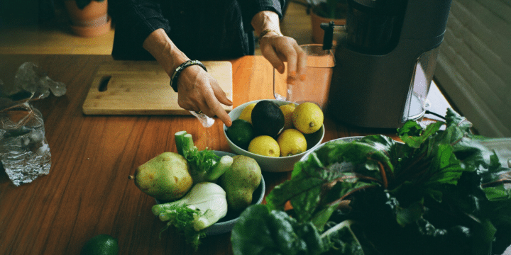 a person pointing at a bowl of fruit