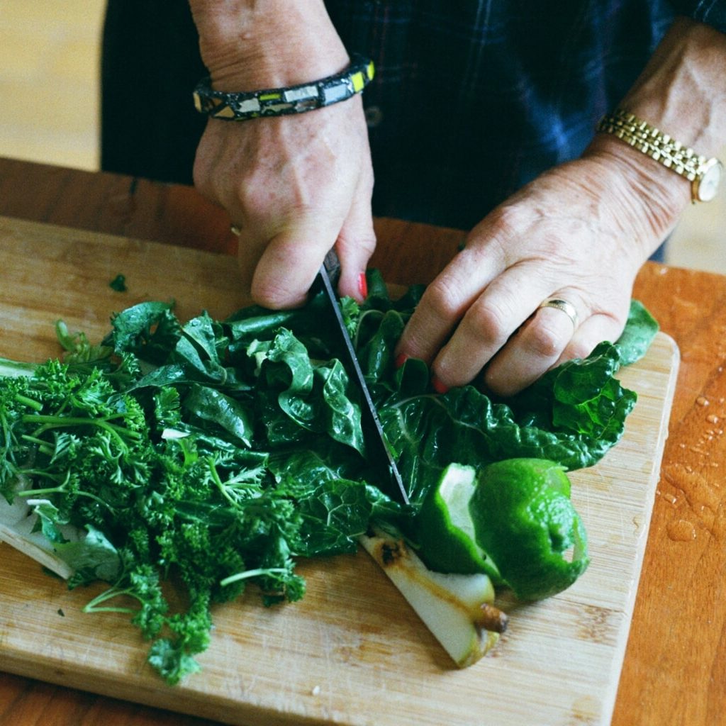 57630023 a person cutting vegetables on a cutting board